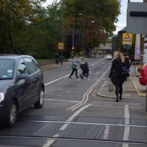 Mortlake, Sheen Lane, level crossing with children running across the road