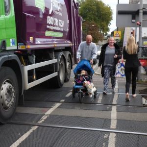 Mortlake, Sheen Lane, family on level crossing in rush hour